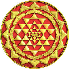 Golden Sri Yantra geometric design on a red background, symbolizing spiritual and cosmic harmony.