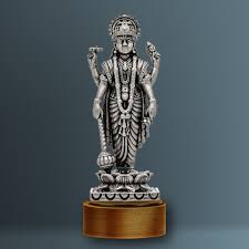 A metallic idol of Lord Dhanvantari standing on a pedestal, holding the pot of Amrit and healing herbs.